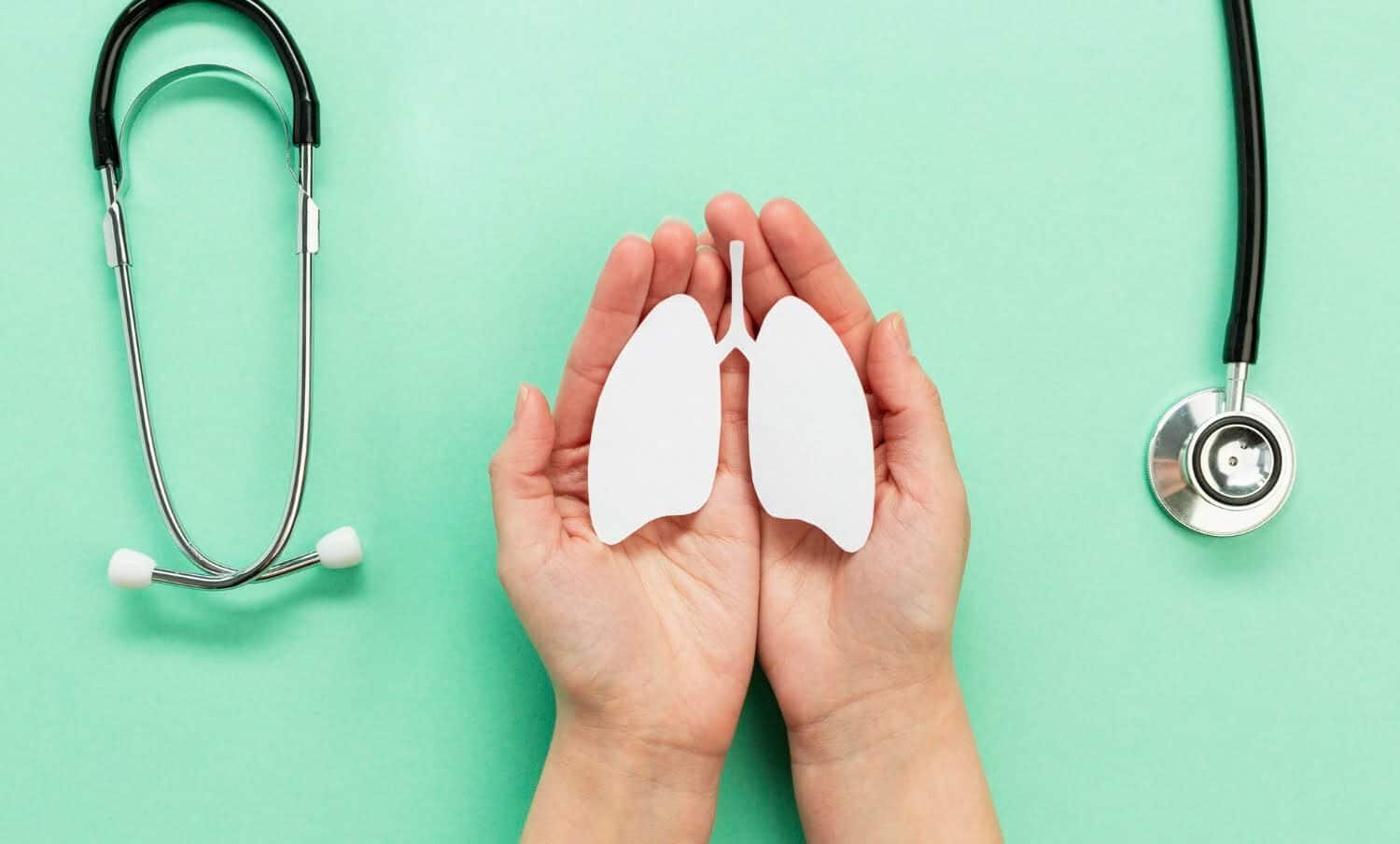 manos sosteniendo pulmones hechos de papel