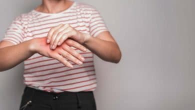 Mujer masajeando sus manos para aliviar calambres