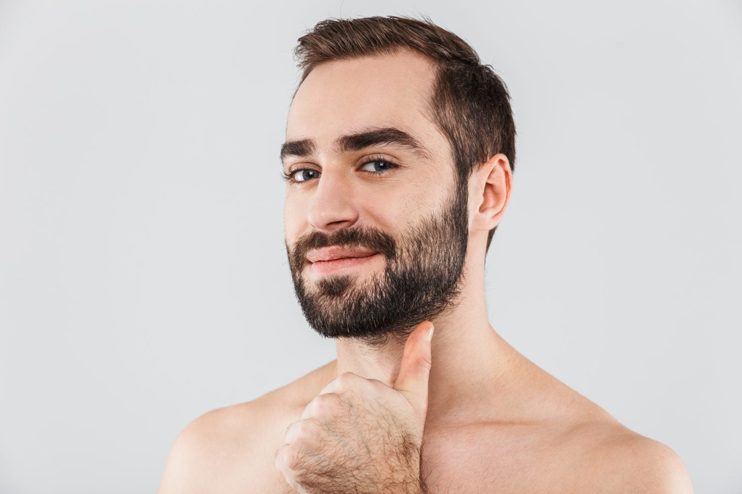 joven guapo sin camisa barbudo que se encuentran aisladas sobre blanco barba so&ntilde;ada