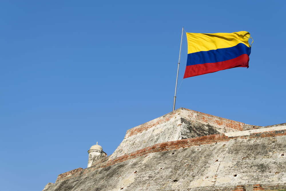 Una bandera colombiana ondea al viento sobre los muros erosionados de la fortaleza del Castillo San Felipe de Barajas en Cartagena de Indias, Colombia / Colombia