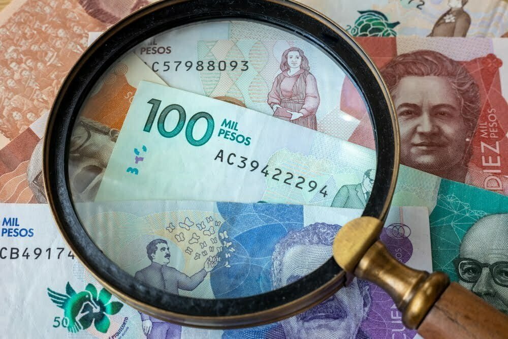 Dinero colombiano, altas denominaciones, lupa / billetes falsos